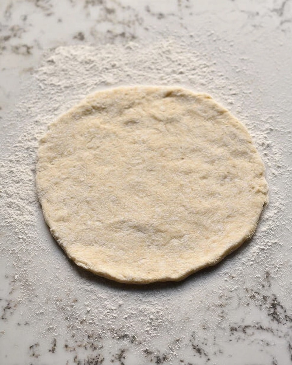 A small round bowl holds creamy hummus in a light beige color, swirled with olive oil that pools in the center and sprinkled with black pepper. A woman's hand is dipping a triangular piece of flatbread, which has golden brown spots on a soft white surface, into the hummus. In the top left corner, there is a white plate partially visible with more triangular pieces of flatbread stacked on it. At the bottom left, a small bowl contains four slices of fresh cucumber, bright green with pale centers. To the right, a cluster of vine tomatoes, bright red and shiny, rests on a grayish cloth napkin with yellow and white stripes, all placed on a dark wooden table with a white marbled surface background. Photo taken with an iphone --ar 4:5 --v 7