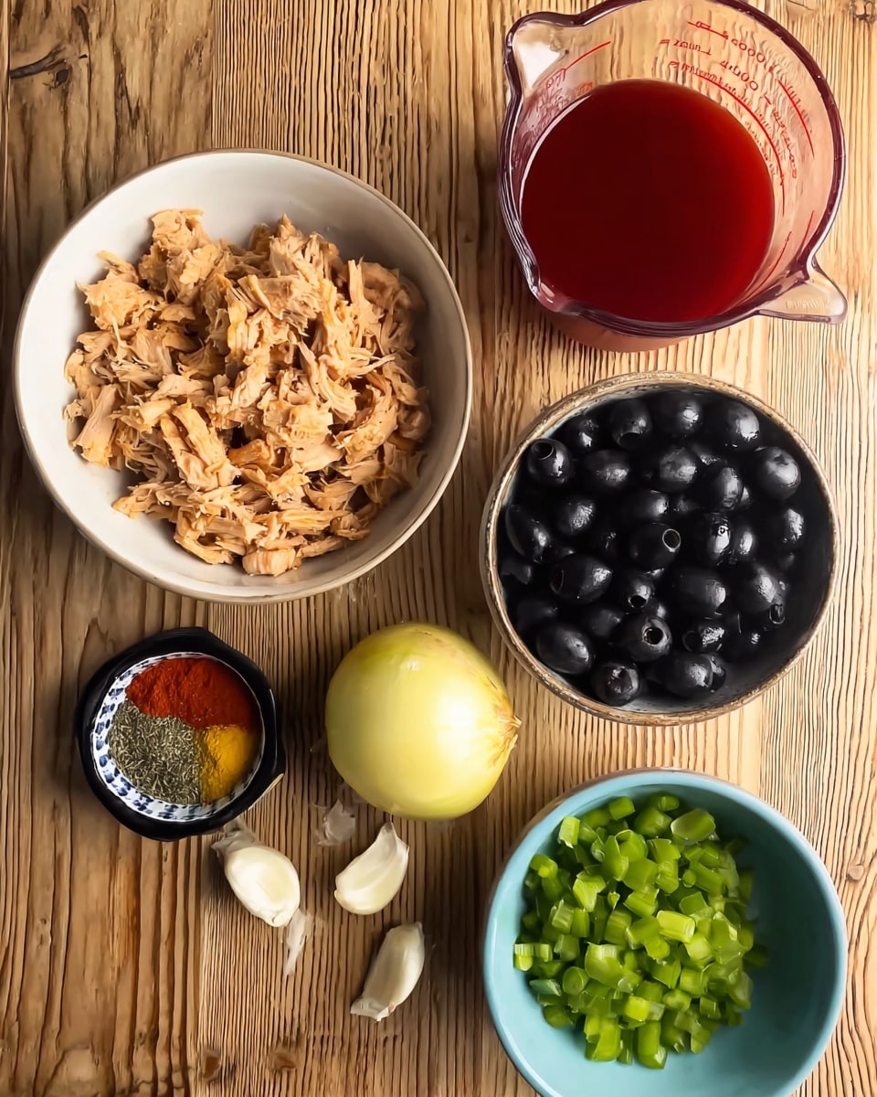 The image shows six main items arranged on a wooden surface. In the center left is a white bowl filled with light beige cooked shredded meat. Above it, slightly to the right, is a small round bowl filled with black olives, each glossy and whole. Next to the olives on the top right is a clear glass measuring cup holding bright red liquid. To the left of the white bowl is a small black-rimmed dish with a mix of ground spices—red and green powders. Below the measuring cup and to the right of the meat is a whole yellow onion and five garlic cloves scattered beside it. At the bottom right is a light blue bowl filled with small green diced vegetables. The surface is wooden with visible grain patterns. photo taken with an iphone --ar 4:5 --v 7