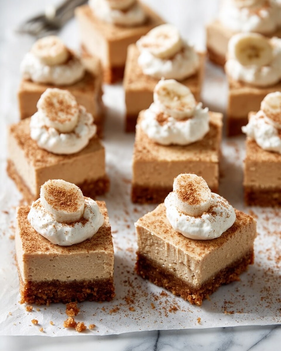 The image shows several square dessert bars arranged on a white marbled surface. Each bar has two layers: a thick, crumbly brown base layer with a rough texture at the bottom, and a lighter tan, smooth, creamy layer on top. Some bars have a dollop of white whipped cream on the top center, sprinkled with a fine brown powder, while others do not have the cream. The bars look soft yet firm and have a slightly grainy surface texture on the creamy layer. Small crumbs are scattered around the bars on the marbled surface. photo taken with an iphone --ar 4:5 --v 7