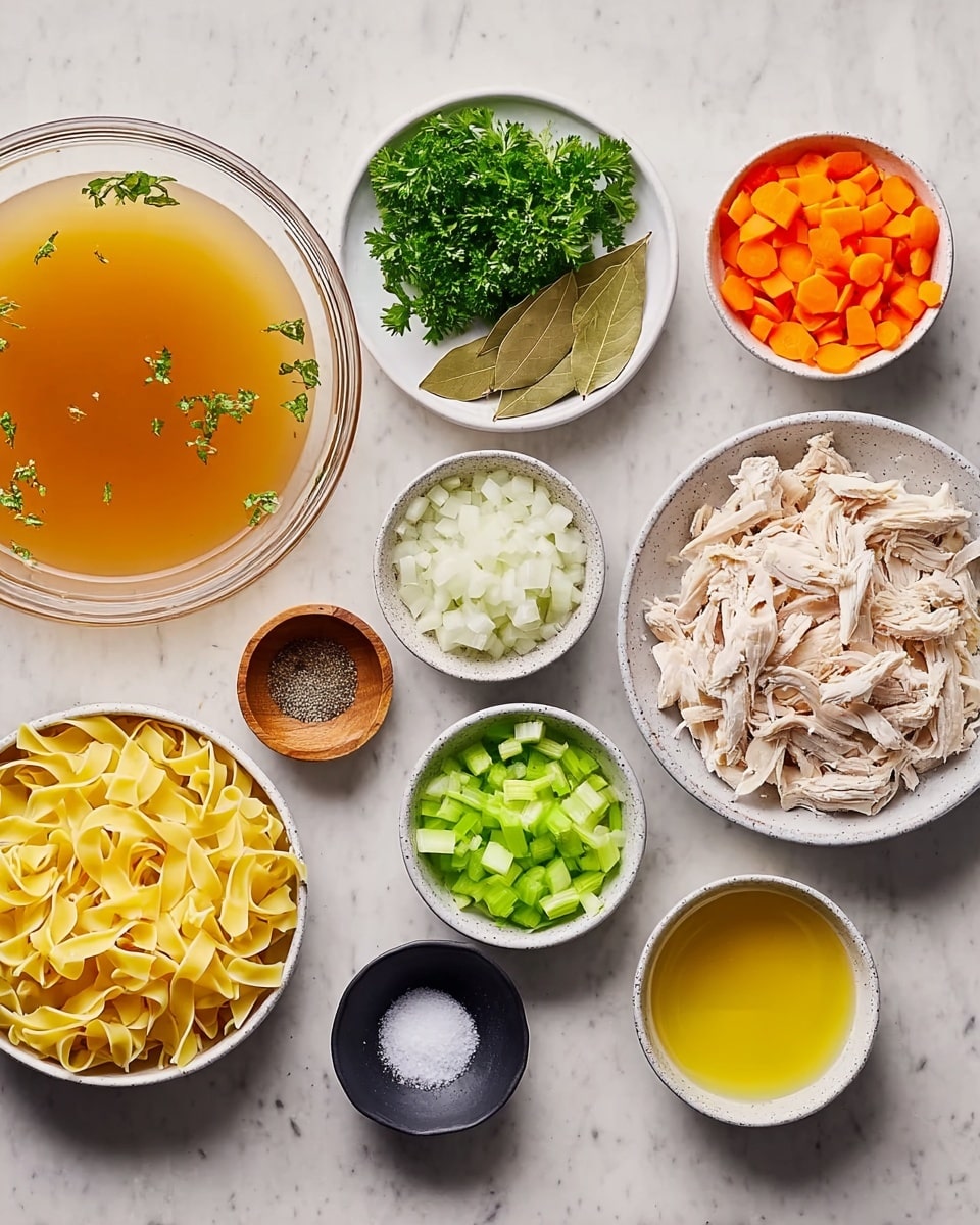 The image shows ingredients for a chicken noodle soup arranged neatly on a white marbled surface. From left to right, there is a clear glass bowl filled with light brown broth with some green parsley above it. Moving right, there is a small white bowl with chopped white onions, below a small wooden bowl with black pepper, next to a grey bowl holding chopped garlic. Above the garlic, a small white dish contains two bay leaves. Next to it is a grey bowl with chopped green celery, followed by a white bowl with shredded cooked chicken on the far right. In front of the shredded chicken is a small white bowl with light yellow oil, and next to it a grey bowl holding wide, uncooked yellow egg noodles. Near the front center, there is a small black bowl with salt. The colors include light orange from carrots, white from onions and chicken, green from celery and parsley, black pepper, and yellow noodles, all forming a tidy arrangement. photo taken with an iphone --ar 4:5 --v 7