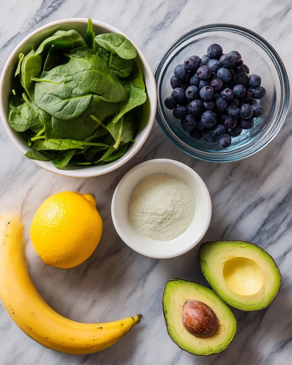 A top view of a glass filled with a thick light green smoothie topped with a small pile of light yellow hemp seeds on one side and three fresh dark blue blueberries on the other side, sitting on a white plate with a wooden texture underneath. In the background on a white marbled surface is a blurred half avocado and some scattered dark blue blueberries. Photo taken with an iphone --ar 4:5 --v 7