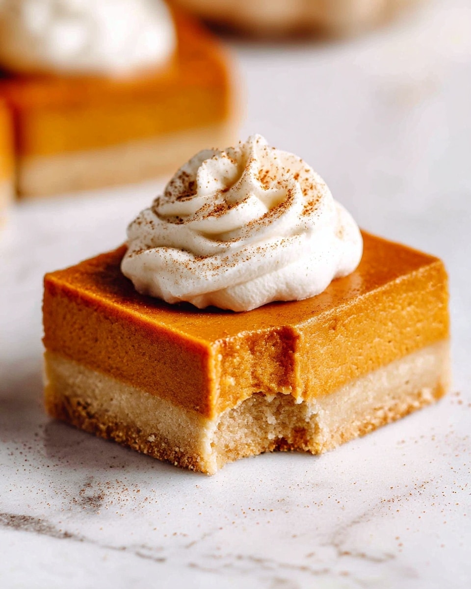 The image shows four square slices of pumpkin dessert bars arranged on a light beige surface. Each bar has two layers: a thick bottom layer that is light brown with a crumbly texture, and a thicker top layer that is smooth and orange in color, resembling pumpkin filling. On top of each bar is a small swirl of white whipped cream dusted lightly with cinnamon or a similar brown spice. One square is stacked slightly on top of another, showing the texture of both layers clearly. The background surface has a soft, slightly rough texture with some crumbs scattered around. photo taken with an iphone --ar 4:5 --v 7