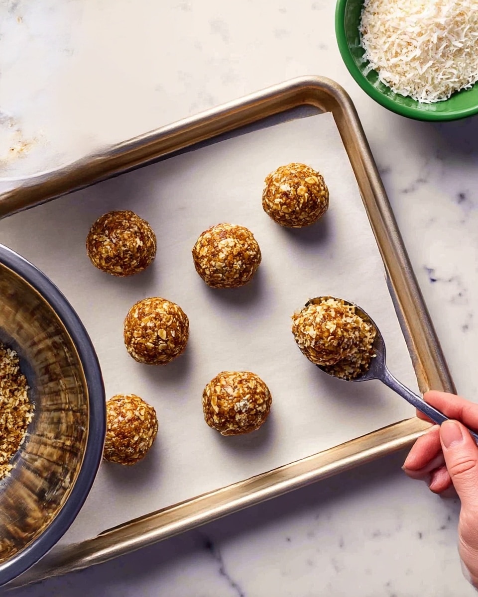 The image shows many round balls arranged on a white plate. The balls have two types of coating: some are covered with small white coconut flakes, and others are covered with small brown nut pieces. The colors vary between light brown with white flakes and light brown with nut bits, creating a textured look. The plate is placed on a white marbled surface, and there is a white bowl filled with white coconut flakes beside the plate. The balls are arranged close to each other in rows, filling the plate evenly. photo taken with an iphone --ar 4:5 --v 7