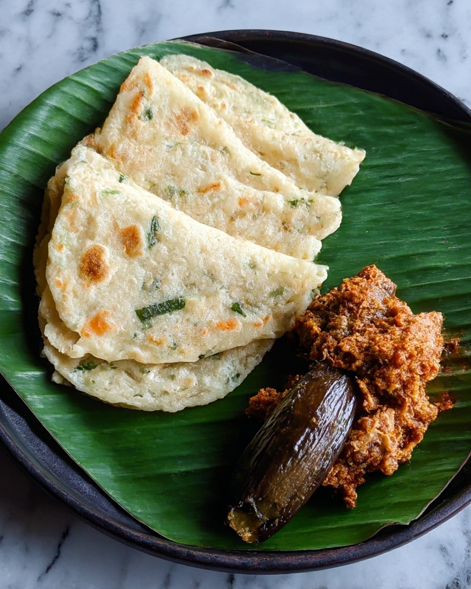 The image shows a close-up of a round, thin pancake cooking on a black pan. The pancake is light in color with uneven golden brown spots on the surface, giving it a slightly crispy look. Small green pieces, likely herbs or vegetables, are scattered evenly throughout the pancake, along with small bits of orange and white ingredients. The texture looks soft with some small holes and bubbles visible on top. The pan's black surface contrasts with the light pancake, making the colors stand out well. The background is not clearly visible. photo taken with an iphone --ar 4:5 --v 7