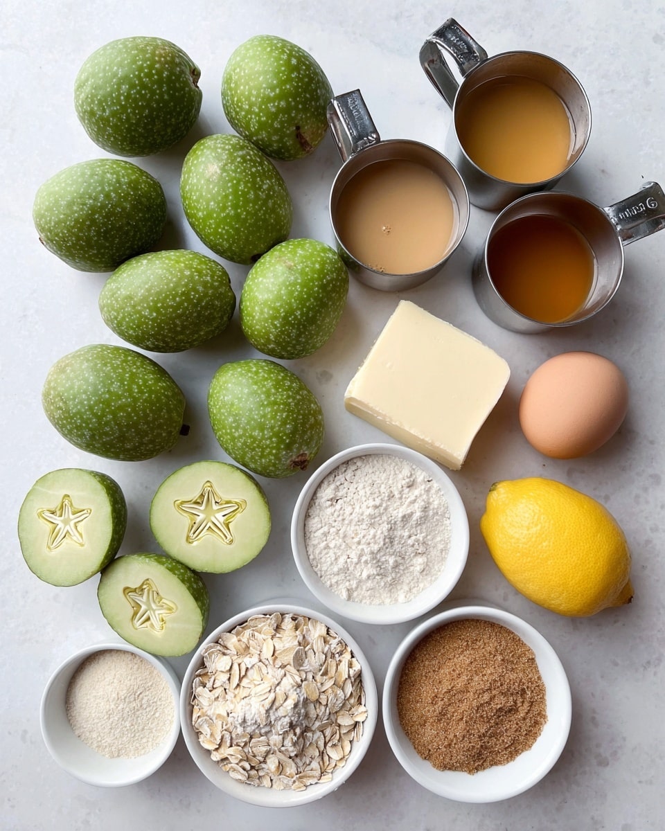 The image shows a group of fresh feijoa fruits with green, bumpy skin, one of which is sliced in half to reveal a pale, creamy inside with a star-like seed pattern. Next to them are two brown eggs and one bright yellow lemon. There are small white bowls containing light brown sugar, oats, a mixture of white powders with one tan powder, and a small bowl of a yellow liquid with black specks. Three measuring cups hold light beige flour, bright white flour, and amber-colored honey. A neat rectangular block of pale yellow butter rests on parchment paper. All items are arranged on a white marbled surface photo taken with an iphone --ar 4:5 --v 7
