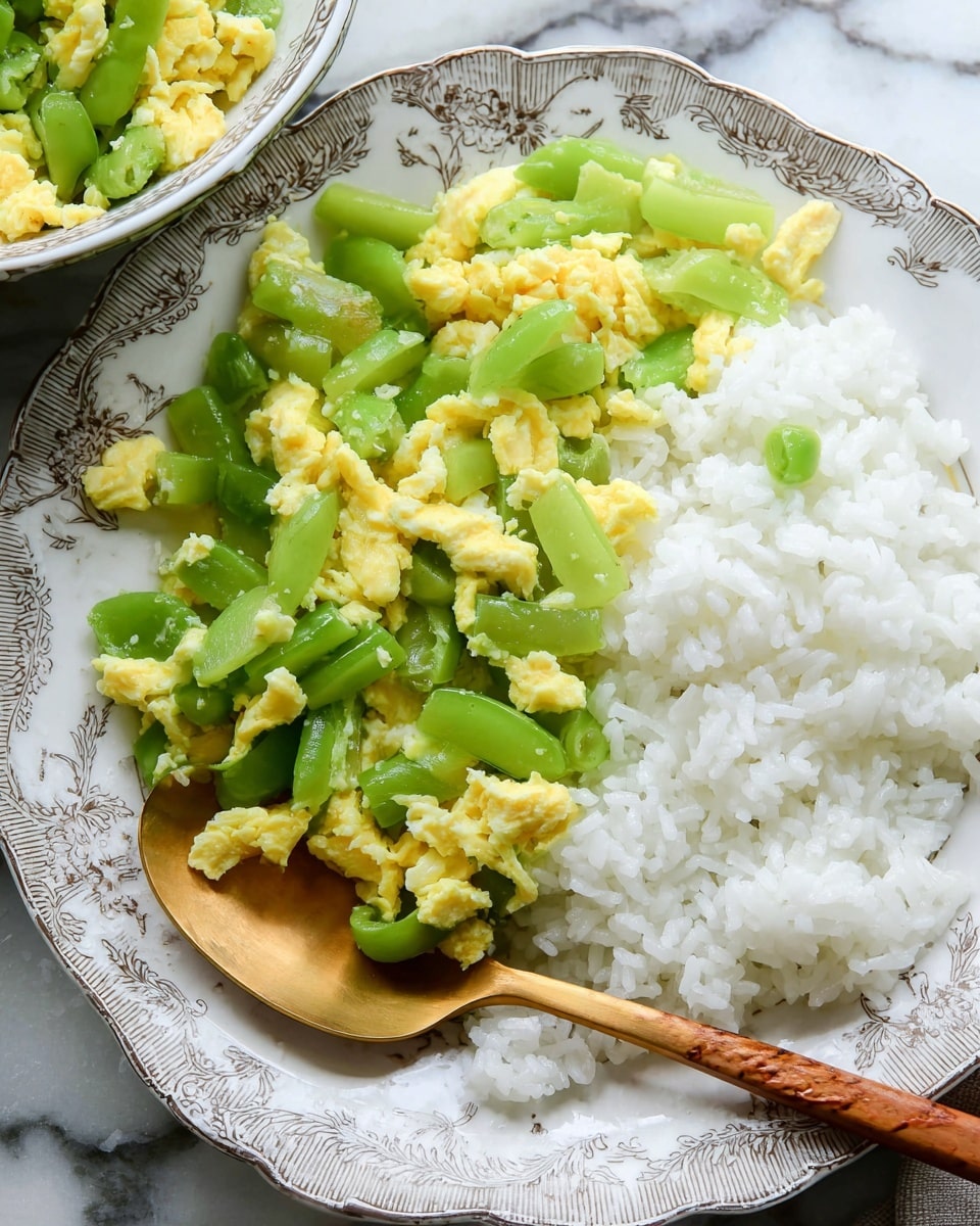 A blue and white patterned bowl filled with a mix of light green, sliced cooked vegetables and soft yellow scrambled eggs, evenly spread throughout the dish. The bowl sits on a table with a white marbled texture, beside a white plate filled with white rice and a white rectangular plate with a piece of cooked fish that has a golden-brown crispy skin. A pair of wooden chopsticks is near the bowl and part of a woman’s hand with a red and white striped cloth is visible in the corner. Photo taken with an iphone --ar 4:5 --v 7