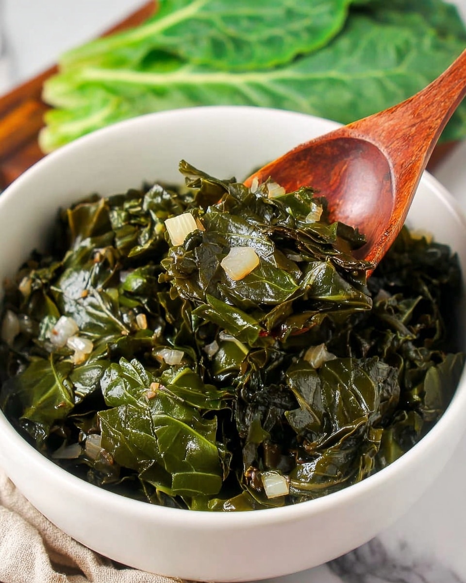 A close-up view of dark green, cooked leafy greens with visible bits of seasoning on a wooden spoon, held above a white bowl filled with more cooked greens; a tan cloth with white dotted pattern is partially visible on the right side, and the background is a white marbled texture photo taken with an iphone --ar 4:5 --v 7