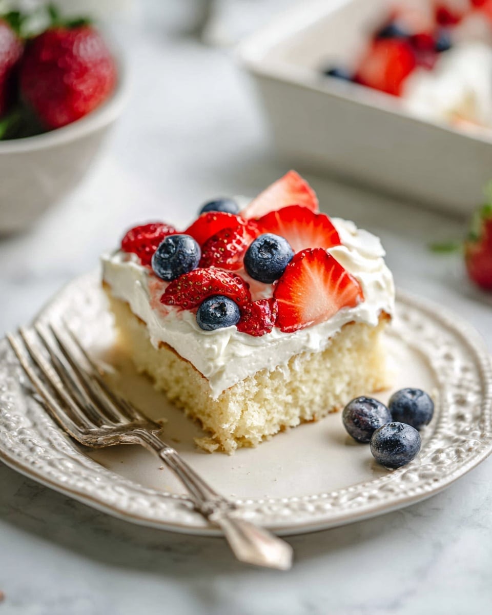 A rectangular clear glass dish with a dessert made to look like the American flag on a white marbled surface. The bottom layer is covered in white creamy frosting topped with shredded coconut forming white stripes. Bright red strawberry slices form four red stripes evenly spaced across the dish. A blue rectangle made of fresh blueberries fills the top left corner, with small white mini marshmallows scattered inside the blue rectangle. Around the dish are small white bowls, one with halved strawberries, one with blueberries, one with shredded coconut, and one with mini marshmallows. Photo taken with an iphone --ar 4:5 --v 7