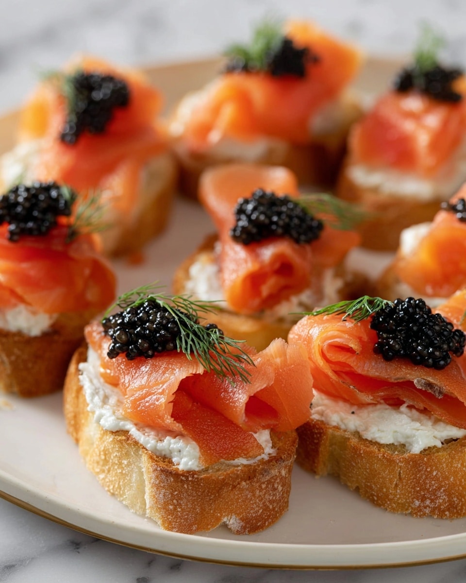 The image shows small white oval toast slices evenly spread on a white oval plate over a white marbled surface, each with a three-layer stack: the first creamy white cheese spread layer, topped with a bright pink slice of smoked salmon that has a soft, slightly shiny texture, and finished with a small mound of shiny black caviar and a delicate green dill sprig on top. Nearby, on another smaller white round plate, are three more toasts with the same layers, alongside a small white bowl filled with fresh green dill sprigs. In the background, there is a wooden pepper grinder and a bottle of olive oil, all set on the white marbled surface. Photo taken with an iphone --ar 4:5 --v 7