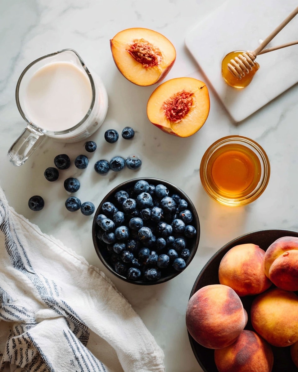 A white marbled surface with a small black cup full of dark blue blueberries in the center, some scattered around it; above are peach slices and a peach half showing its pit on the right; below is a clear measuring jug filled with white milk slightly tilted and a small glass container filled with golden honey to its right; next to the measuring jug, on the left side, is a white and grey striped cloth, and on the bottom right corner, a dark bowl filled with whole peaches and a single peach on the surface nearby photo taken with an iphone --ar 4:5 --v 7
