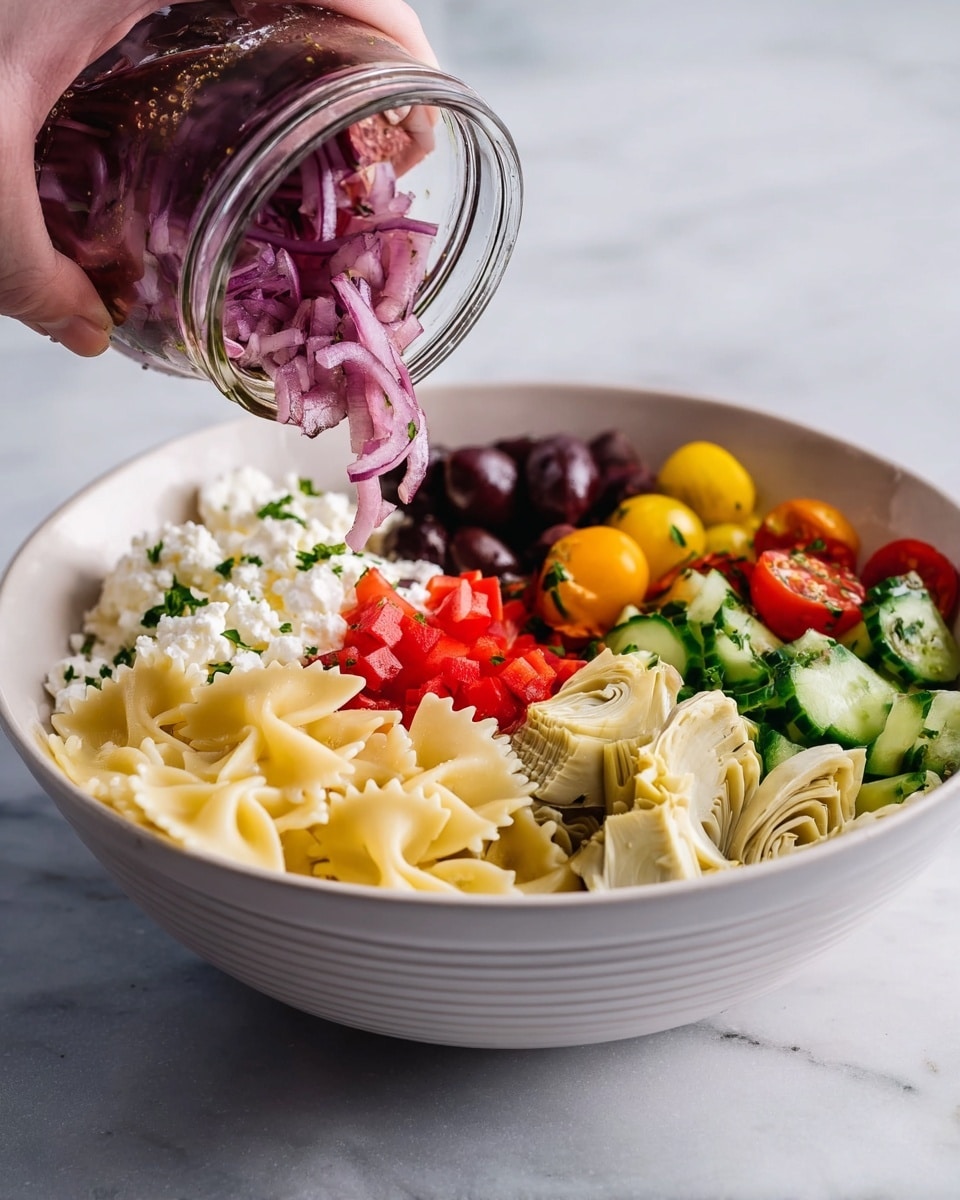 A white bowl sitting on a white marbled surface holds a colorful layered salad. Starting from the left side, there is a layer of light yellow bowtie pasta, followed by a layer of soft white cottage cheese. Next to it is a small pile of finely chopped bright red bell peppers. In the middle, dark purple olive slices form a layer next to fresh green parsley. Behind the parsley, halves of yellow and red cherry tomatoes add bright pops of color. To the right, sliced green cucumber pieces and tender light beige artichoke hearts complete the layers. Above the bowl, a woman’s hand holds a glass jar tipping thin, purple-red pickled onions down over the salad. photo taken with an iphone --ar 4:5 --v 7