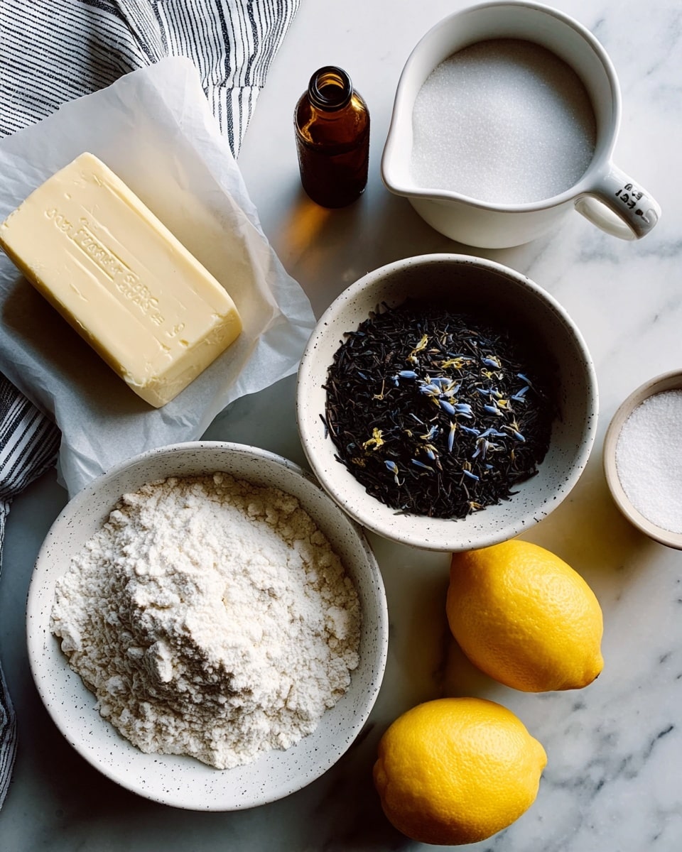 The image shows several ingredients arranged on a white marbled surface. In the lower center, a white bowl holds a heap of white flour with a rough texture. Above it, a speckled white bowl contains dark loose tea leaves with hints of blue petals mixed in. To the left, a stick of pale yellow butter rests partially wrapped in white paper, placed on a striped cloth. Above the butter, a large white measuring cup is filled with fine white sugar. To the right of the sugar, a small brown glass bottle sits upright. In the top right corner, a small white bowl contains a fine white powder, likely salt. Two bright yellow lemons, one on the far left and one on the far right, add pops of color. The composition is neat and bright with a clean, fresh feel. Photo taken with an iphone --ar 4:5 --v 7