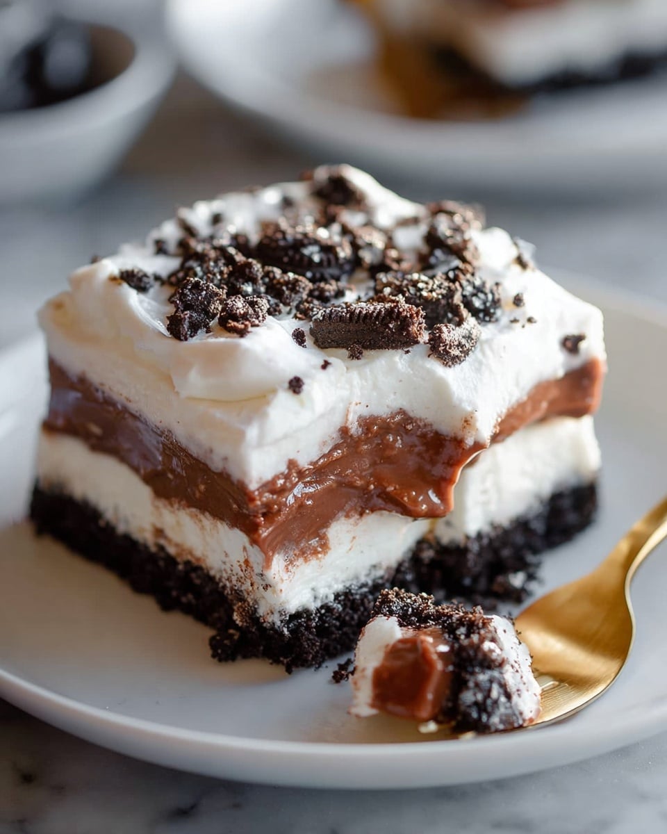 The image shows a rectangular glass dish filled with a four-layer dessert. The bottom layer is dark and crumbly, made of crushed cookies forming a firm base. Above it is a thick white layer with a smooth and creamy texture. On top of this, there is a thick layer of chocolate pudding that is shiny and rich in color. The topmost layer is fluffy white whipped cream, sprinkled with small chunks of crushed dark cookies scattered unevenly. The dish rests on a white marbled surface. photo taken with an iphone --ar 4:5 --v 7